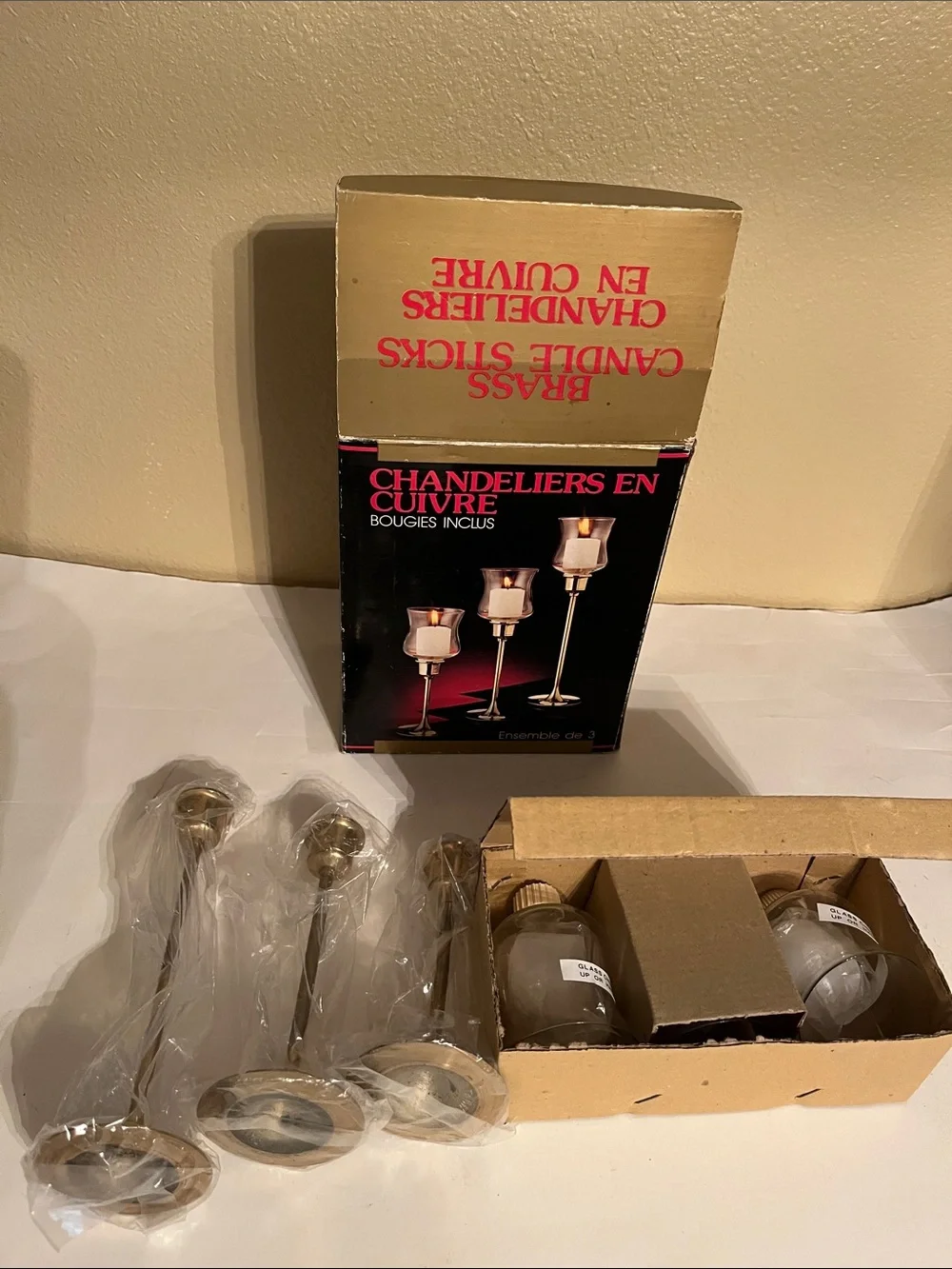 Vintage graduated brass candlestick holders with hurricane glass shades – three